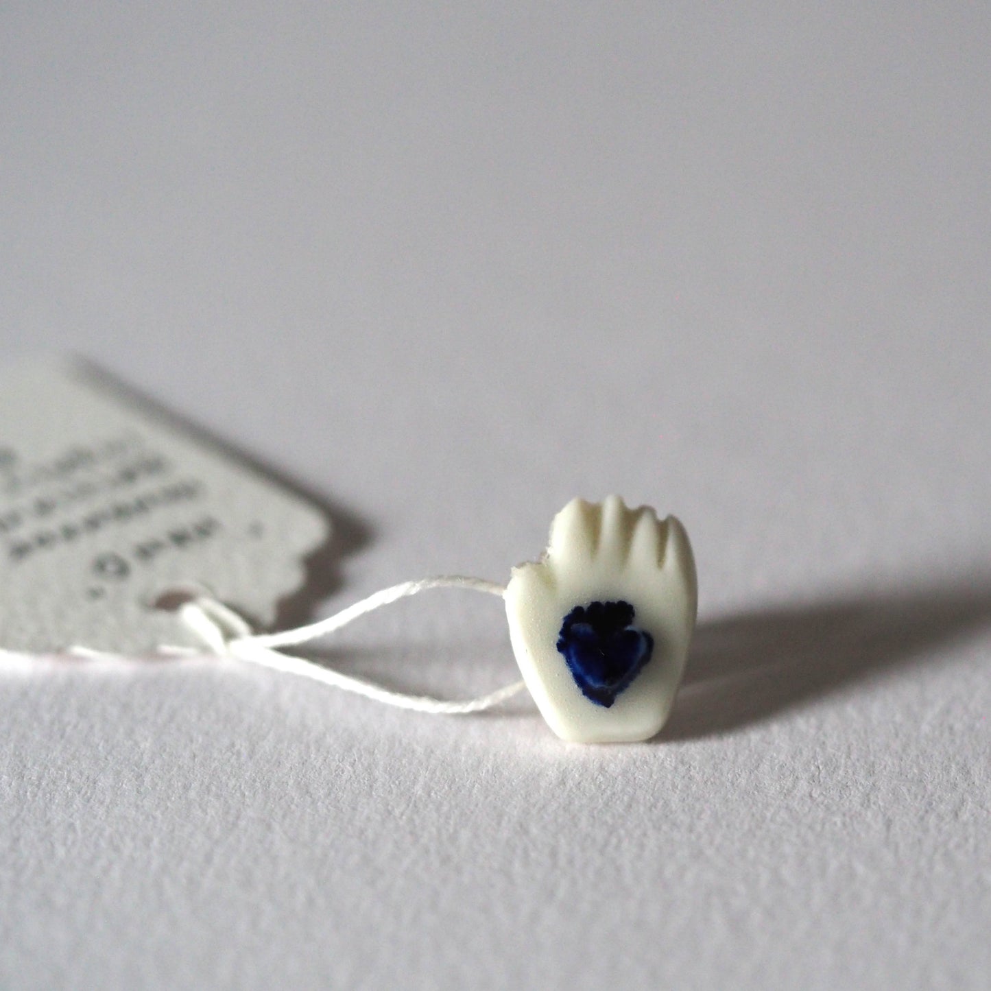 Tiny Porcelain Hand of Generosity Pin-on