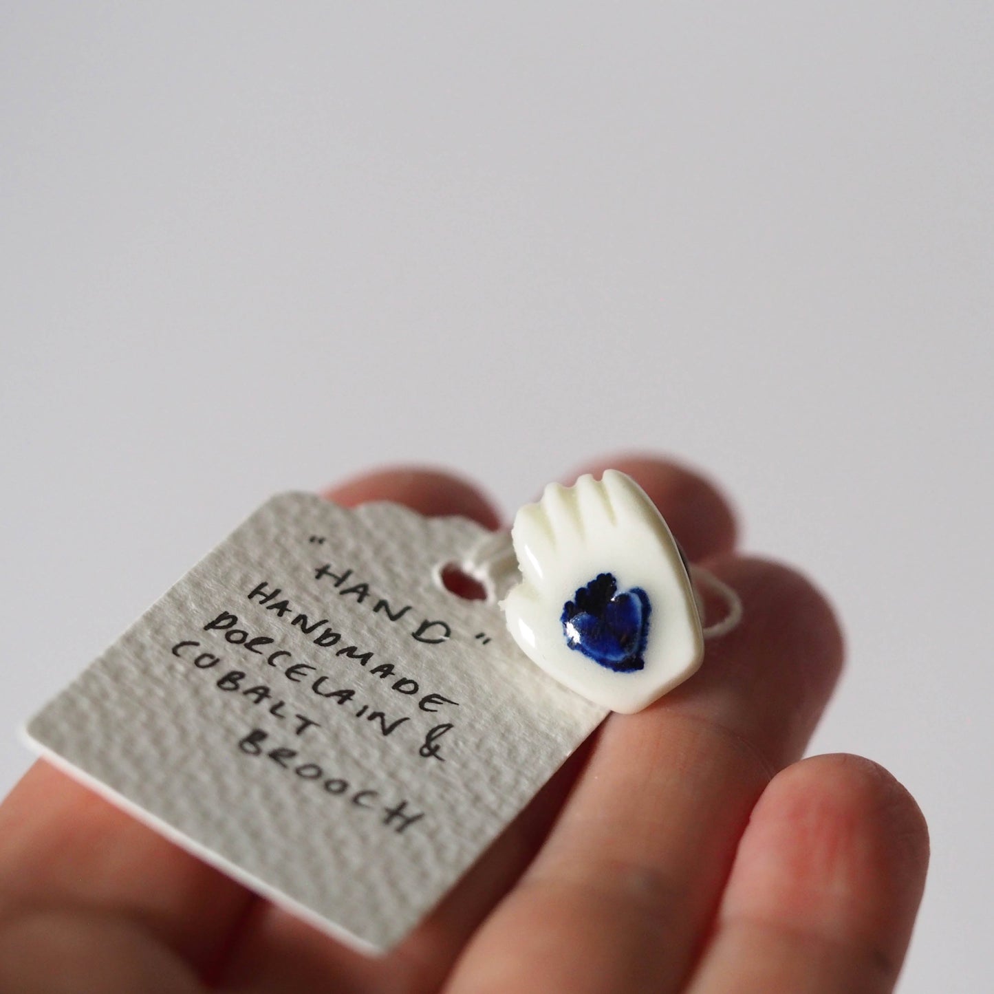 Tiny Porcelain Hand of Generosity Pin-on